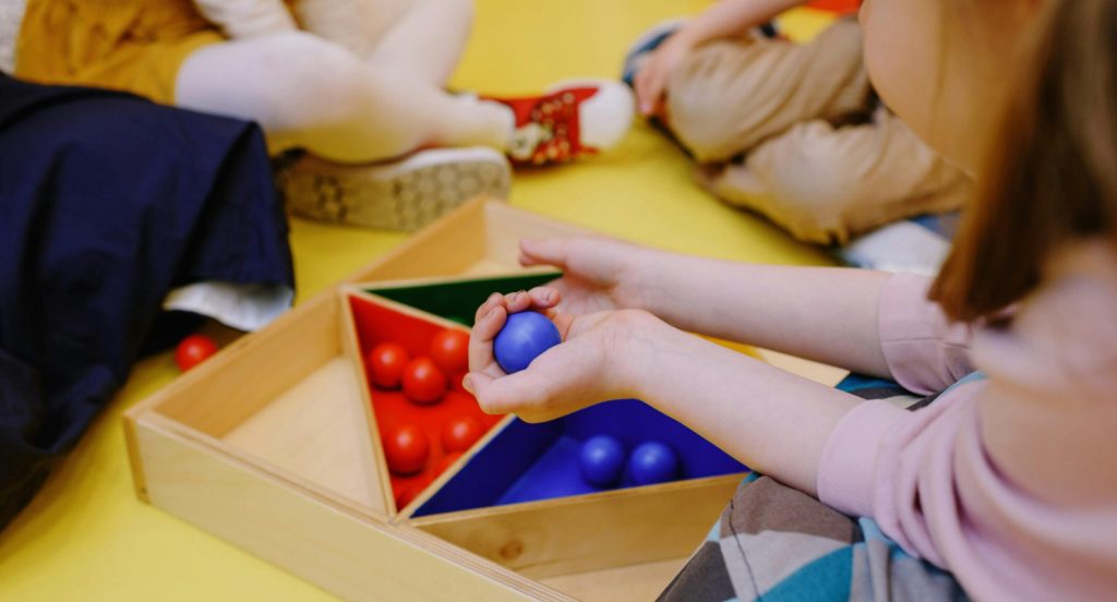 Kids enjoying playtime with educational wooden toys in a friendly environment.